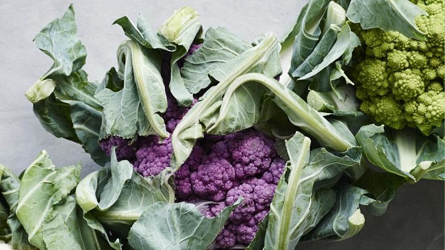 Photo of heads of purple and green cauliflower.